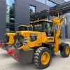 Yellow heavy construction loader with a raised front bucket and large off-road tires, parked outside a dark-gray industrial building; labeled MASSIVE with model 845 on the side.