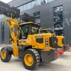 Yellow heavy front-end loader with oversized bucket raised, parked in front of a modern dark-gray building; labeled MASSIVE and 845 on the side, large rugged tires visible.