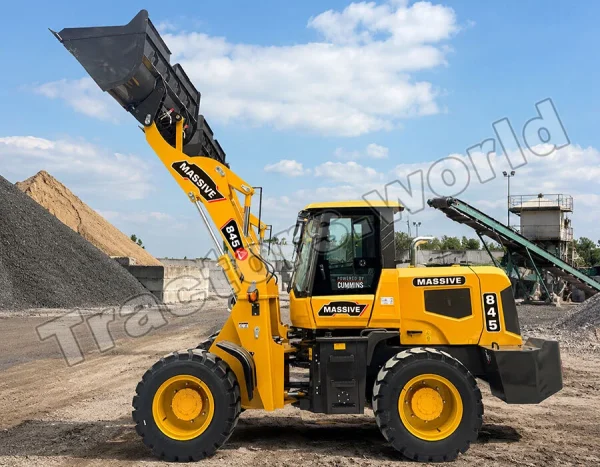 Yellow wheel loader scoops gravel at a quarry with a blue sky and conveyor behind it.